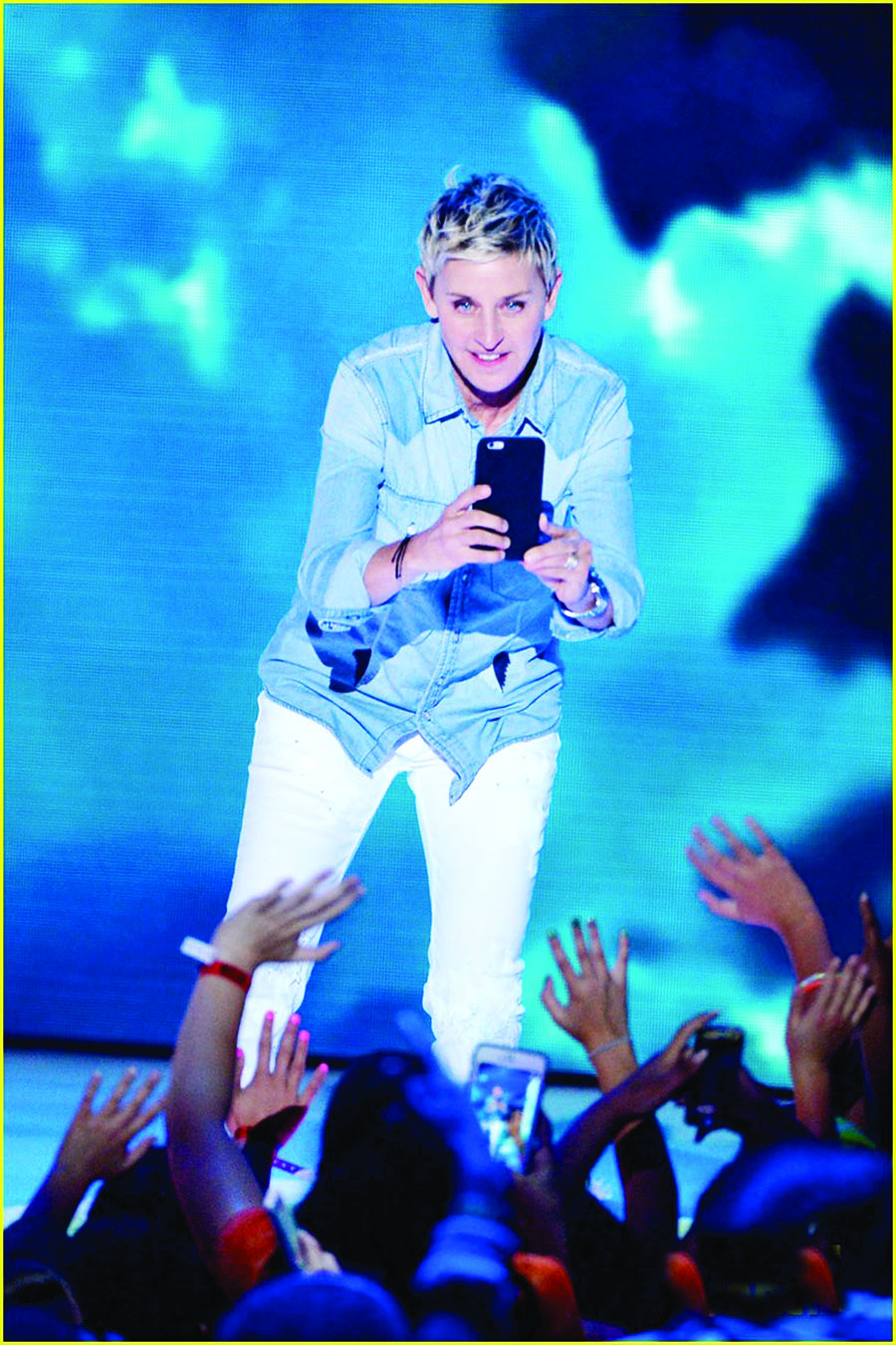 INGLEWOOD, CA - MARCH 12: TV personality Ellen DeGeneres takes a photograph while speaking onstage during Nickelodeon's 2016 Kids' Choice Awards at The Forum on March 12, 2016 in Inglewood, California. (Photo by Kevin Winter/Getty Images)