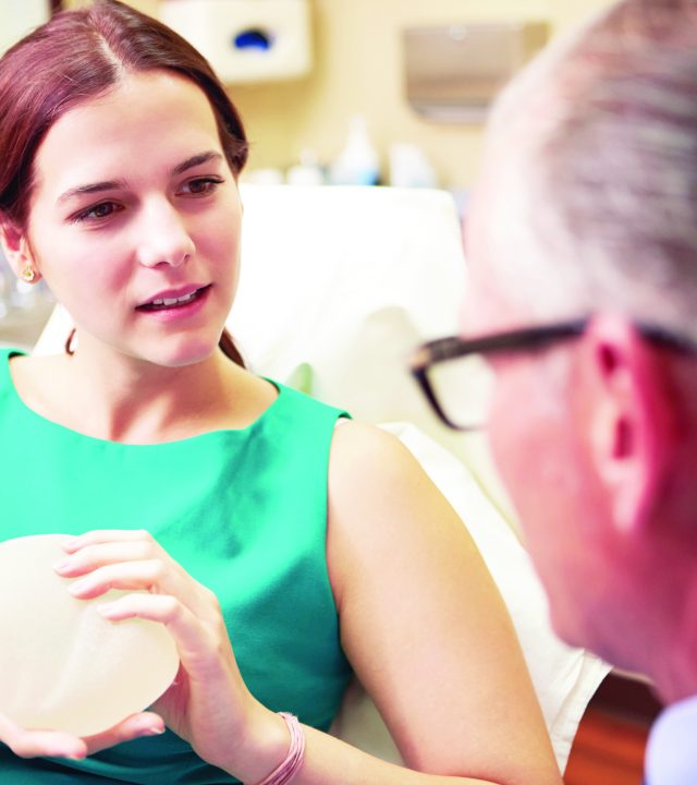 31066910 – woman discussing breast augmentation with plastic surgeon