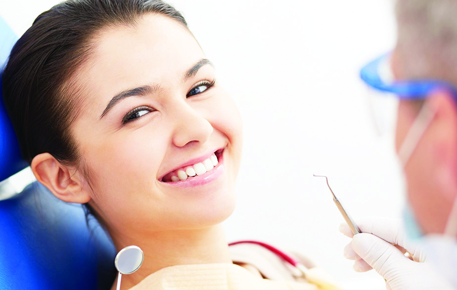 21344599 - image of smiling patient looking at camera at the dentistís